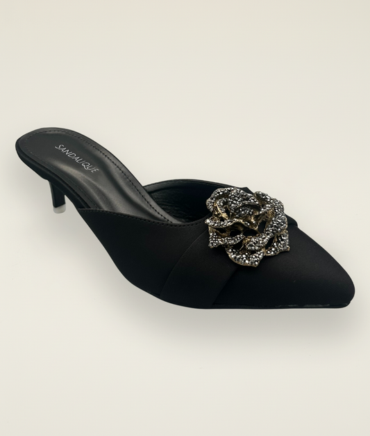 Stylish women’s black medium heel slipper featuring satin finish and jeweled flower buckle